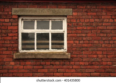 Old Farm Window In Red Brick Wall With Stone Lintel And Cill