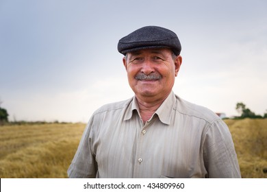 Old farmer is waiting in the middle of the field - Powered by Shutterstock