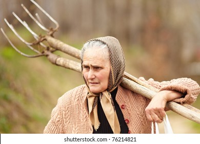 Old Farmer Woman Carrying A Fork, Outdoor