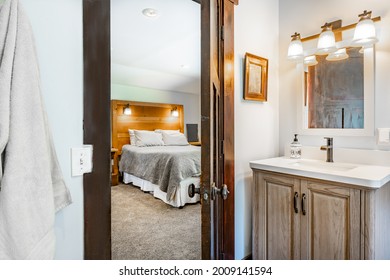 Old Farmhouse Bedroom And Bathroom With Soft Windows Barn Doors And White Fixtures