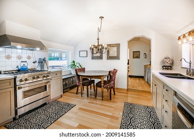 Old Farmhouse Kitchen With Grey Cabinets Dishes Wood Stove And Rustic Walls