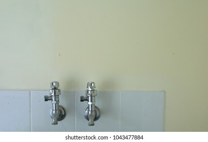 Old Fashion Of Water Taps In The Luandry Room With The Yellow Colour Wall 