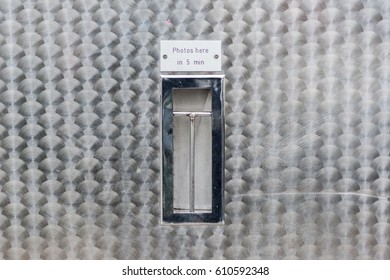 Old Fashioned Analog Photo Booth On The Street In Berlin, Germany.  Metal Exterior And The Picture Strip Slot.