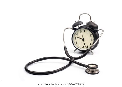 Old Fashioned Black Mechanical Alarm Clock With A Stethoscope Around