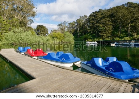 Old fashioned brightly colored pedal boats on Stow Lake in Golden Gate park