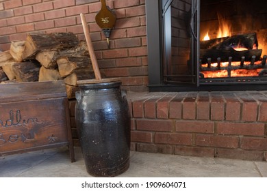 Old fashioned butter churn by the fireplace. - Shutterstock ID 1909604071