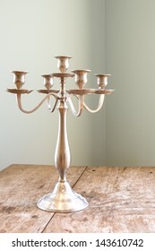 Old Fashioned Candle Stick Holders On A Wooden Table