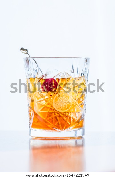 Old\
fashioned cocktail isolated on white\
background