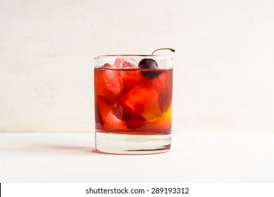 Old Fashioned Cocktail On White Wooden Background