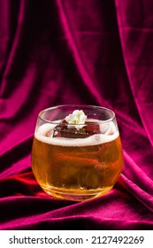 Old Fashioned Cocktail With Whiskey, Classic Old Fashion With A Piece Of Ice On Red Velvet, Retro Crystal Glass Tumbler