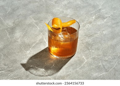 Old fashioned cocktail with whiskey and orange on a wooden table. Hard light. Alcoholic cocktail menu