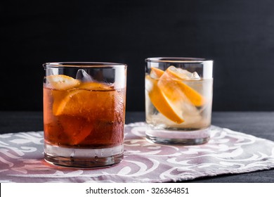 Old fashioned cocktails on the wooden background - Shutterstock ID 326364851