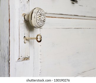 An Old Fashioned Door With A Knob And Skeleton Key