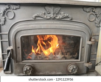 old fashioned fireplace with burning fire 