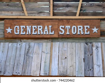 Old Fashioned General Store Sign Mounted On The Wooden Exterior Of A Rustic Building. Copy Space