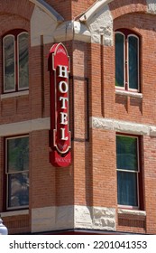 Old Fashioned Generic HOTEL Sign With VACANCY Posted On Red Brick Building In Afternoon Sunshine Representing Lodging, Travel, Vacation, Tourism And Refuge.