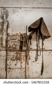 Old Fashioned Horse Barn Interior Stirrup Hanging On The Wall Against Aged Wall No People