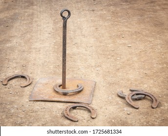 An Old Fashioned Horse Shoe Throwing Game, Set On The Ground.