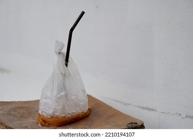      Old Fashioned Iced Coffee Put In A Plastic Bag, Pierced Into A Straw, Ready To Drink.                          