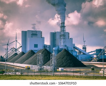 Old Fashioned Industrial Coal Powered Electricity Plant With Pipes And Smoke In Black And White