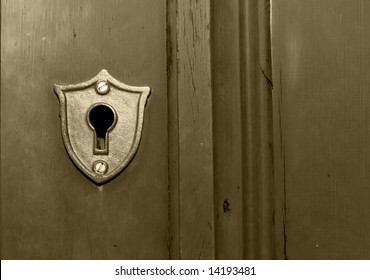 An Old Fashioned Key Hole Built Into A Wooden Door