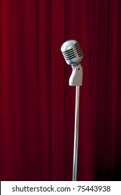 Old Fashioned Microphone On Red Curtain Background