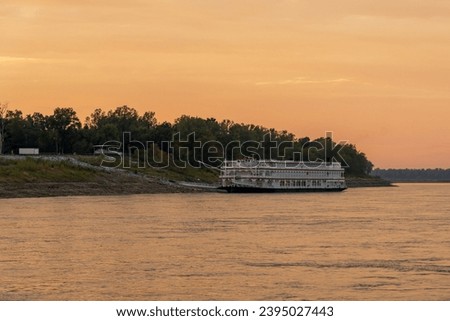 Old fashioned paddle steamer cruise boat docked by slipway in low water conditions on Mississippi river in Tennessee
