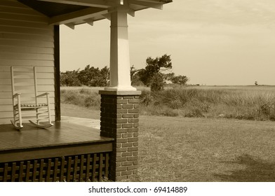 Old fashioned porch with rocking chair overlooking salt marsh