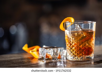 Old Fashioned Rum Drink On Ice With Orange Zest Garnish.