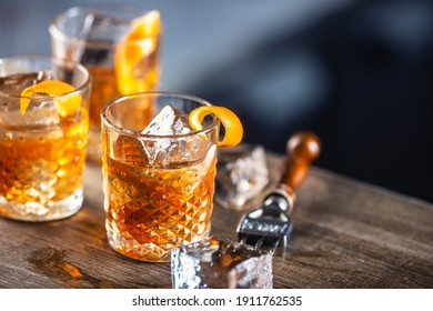 Old Fashioned Rum Drink On Ice With Orange Zest Garnish.