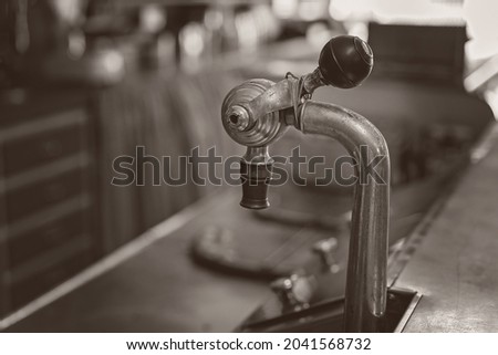 Old fashioned soda fountain on the counter of a retro cafe - monotone image in shallow depth of field