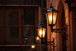 Old Fashioned Street Lamp At Night. Brightly Lit Street Lamps At Sunset. Decorative Lamps. Magic Lamp With A Warm Yellow Light In The City Twilight. Copy Space