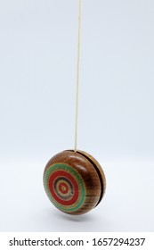 An old fashioned style wooden yoyo. On white background.