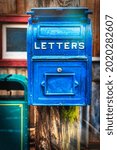 An old fashioned US Post Office mail box hangs on a telephone in Osaka, Japan.