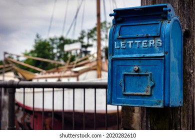 An Old Fashioned US Post Office Mail Box Hangs On A Telephone In Osaka, Japan.