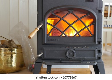 An Old Fashioned Wood Burning Stove With A Roaring Fire.