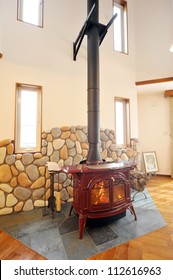 An Old Fashioned Wood Burning Stove With A Roaring Fire-1-1