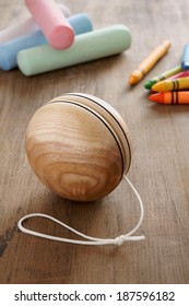 An Old Fashioned Wooden Yo Yo With Chalks And Wax Crayons A Retro Childhood Concept