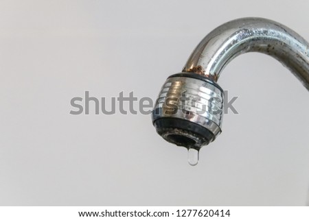 Old faucet damaged, Tap leaking water. (select focus)