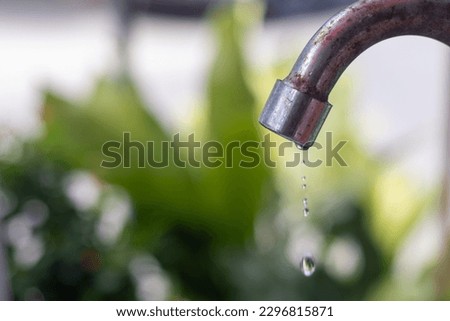 old faucet water droplets water conservation concept saving