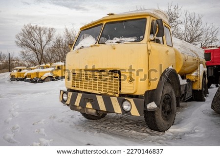 An old and faulty yellow gas station truck.