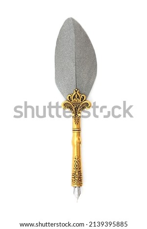 Old feather ornate retro brass quill pen on white background. Top view copy space.