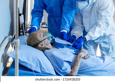 Old female Caucasian patient infected with virus receives oxygen saturation treatment from medical staff in PPE for urgent measure responding to respiratory failure in protective quarantine ward room - Powered by Shutterstock