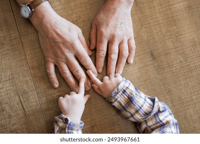 Old female hand holding young baby hand - Powered by Shutterstock