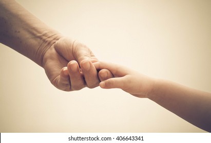 Old Female Hand Holding Young Baby Hand In Vintage Tone