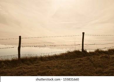old fence under cloudy sky