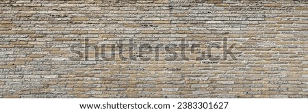 An old fence or wall of a building constructed from shell rock or sandstone blocks. Texture or pattern