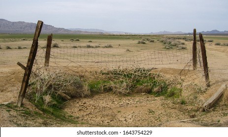 An Old Fenced In Watering Hole On The Dry Lake Bed In Ivanpah Valley.