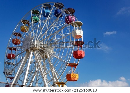 Old Ferris Wheel Over Blue Sky