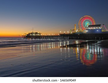 Old Ferris Wheel reflection on wet sand and Santa Monica Pier at twilight shown in Santa Monica, California, United States. - Shutterstock ID 146569049